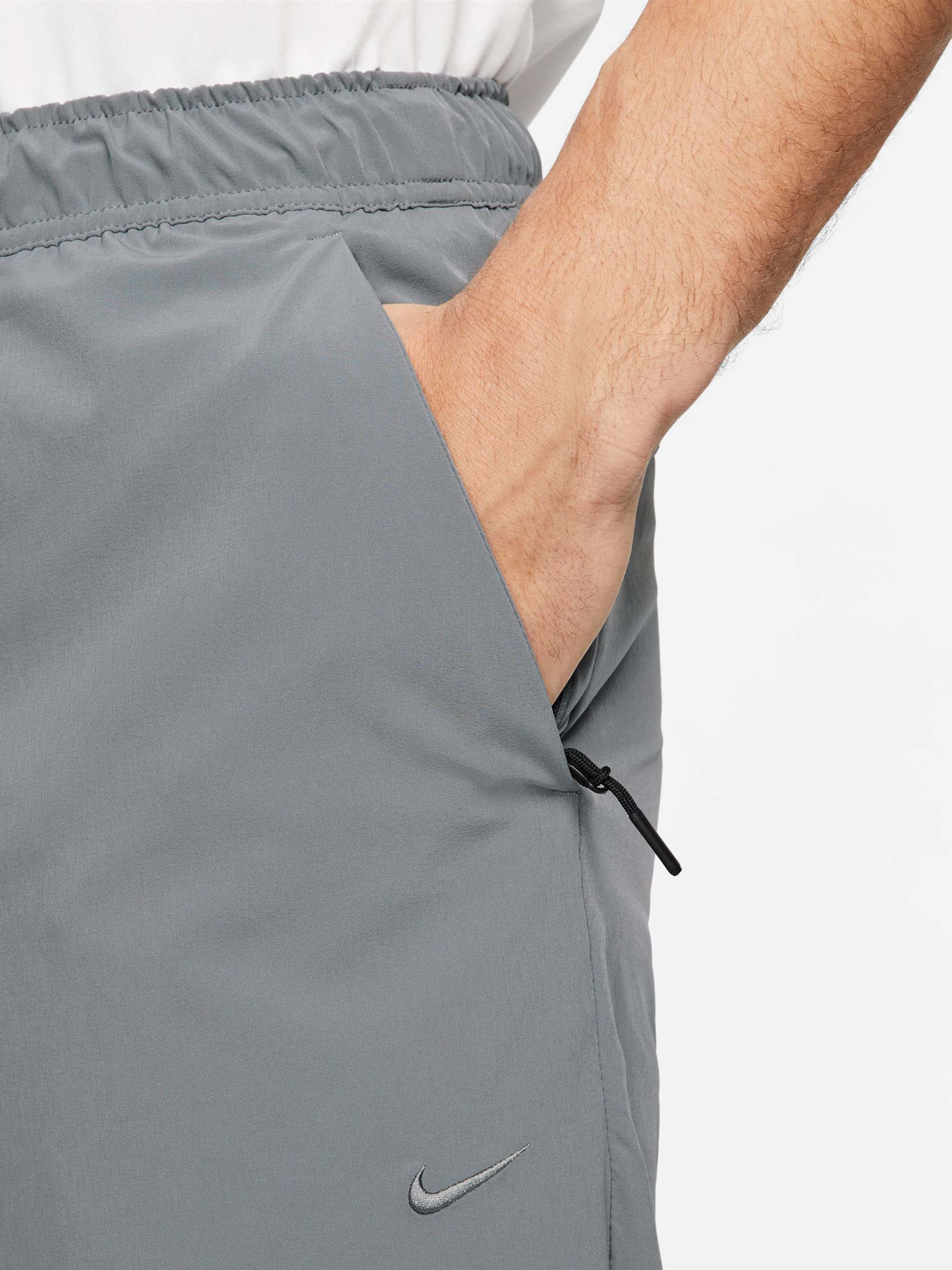 Спортивні штани NIKE DRI-FIT UNLIMITED TAPERED LEG модель FB7548-084 Фото