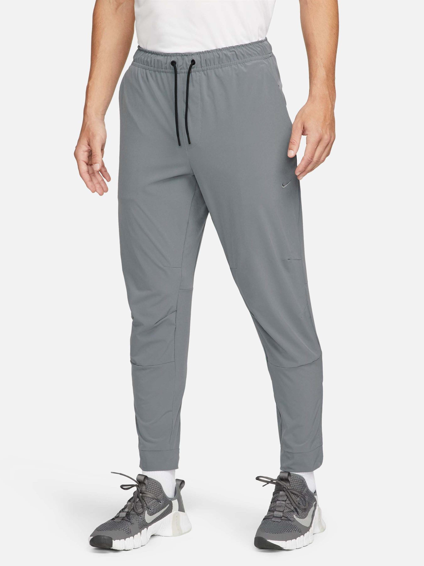 Спортивні штани NIKE DRI-FIT UNLIMITED TAPERED LEG модель FB7548-084 Фото