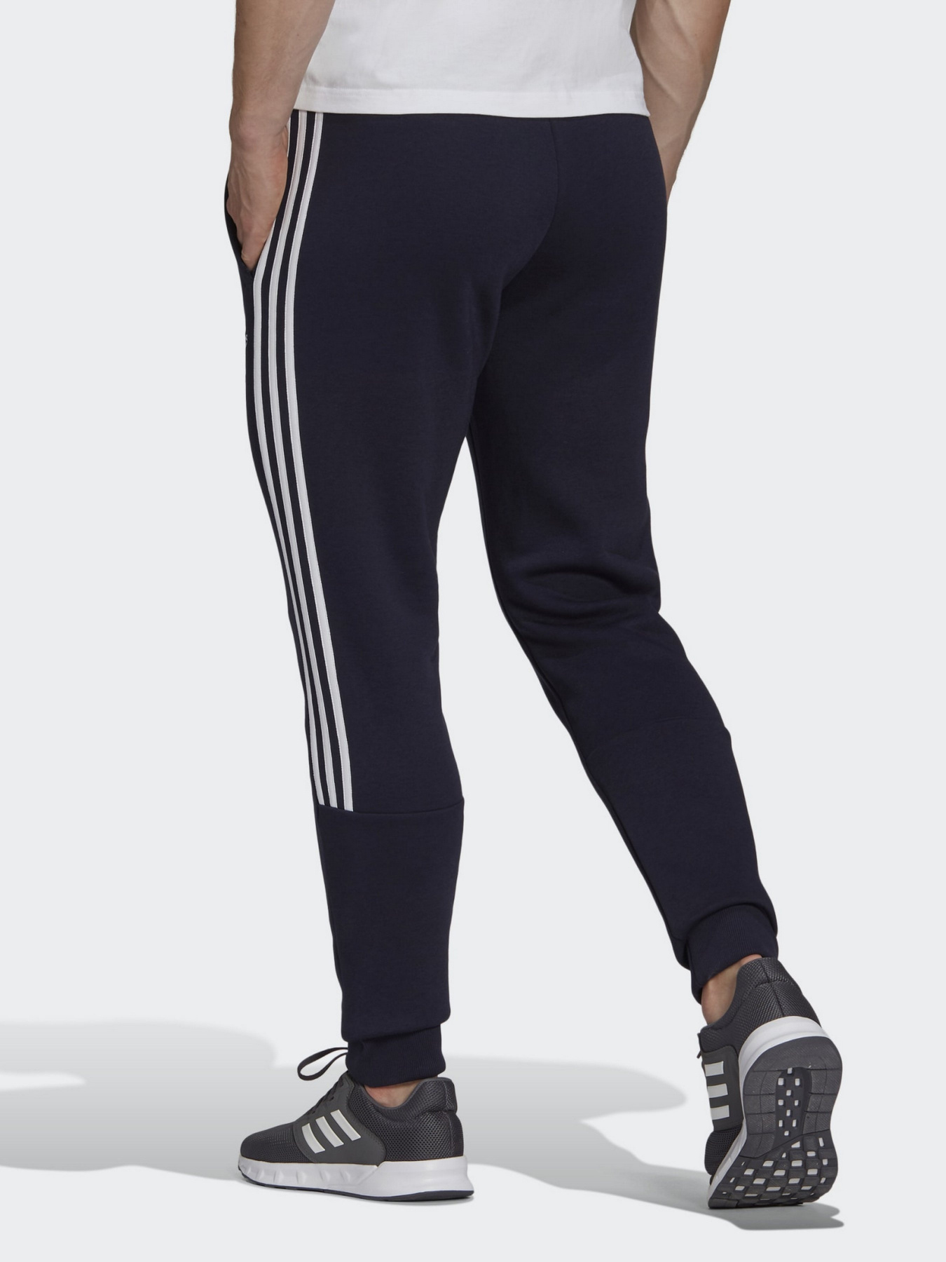 Спортивні штани Adidas ESSENTIALS FLEECE TAPERED CUFF 3-STRIPES модель GK8977 Фото